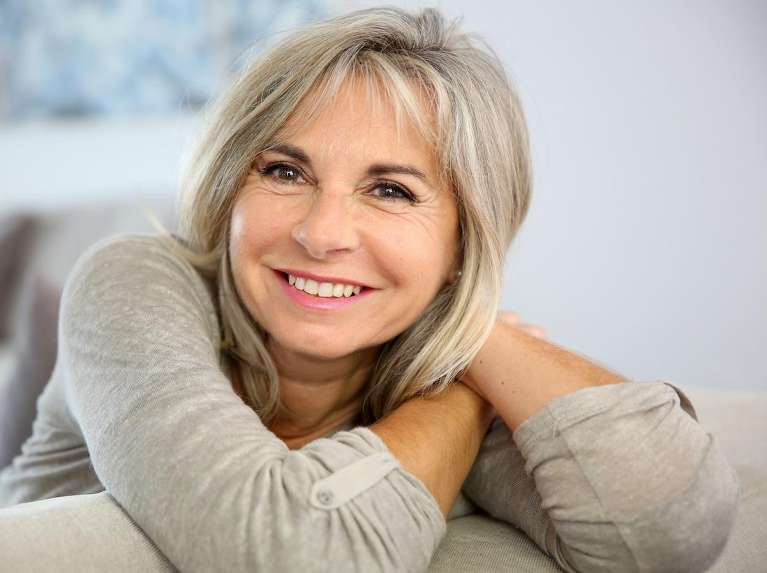 older woman with dental implants in coburg hill